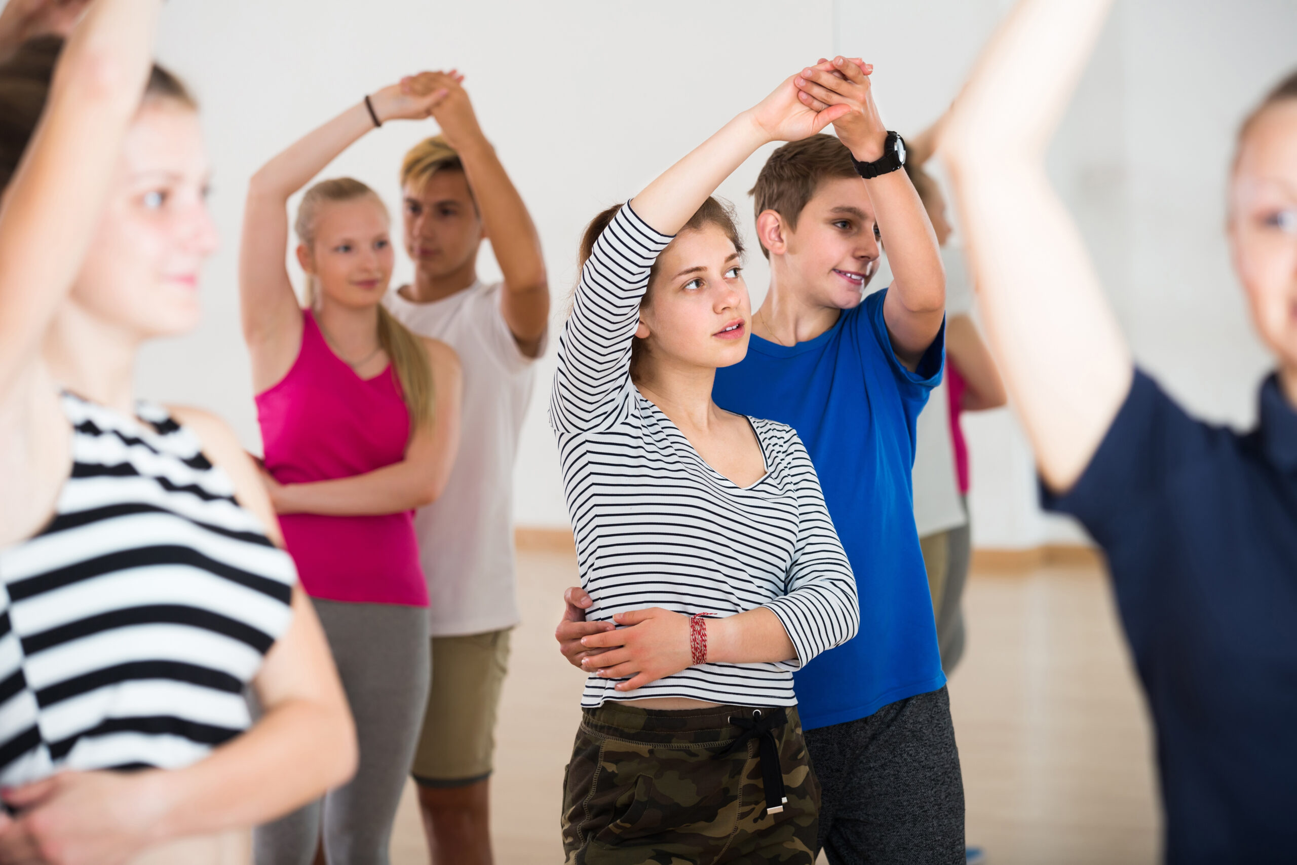 Group of teen dancing salsa in dance studio