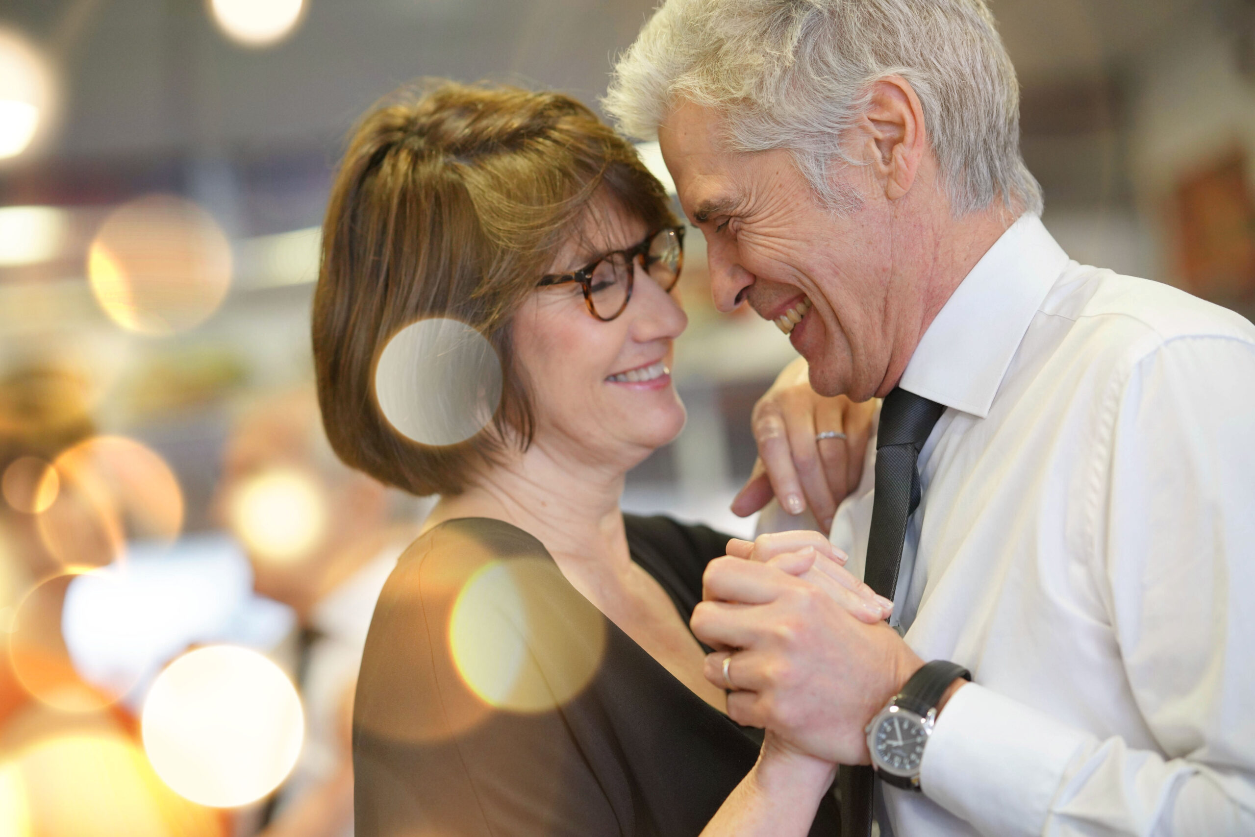 Romantic senior couple dancing together at dance hall