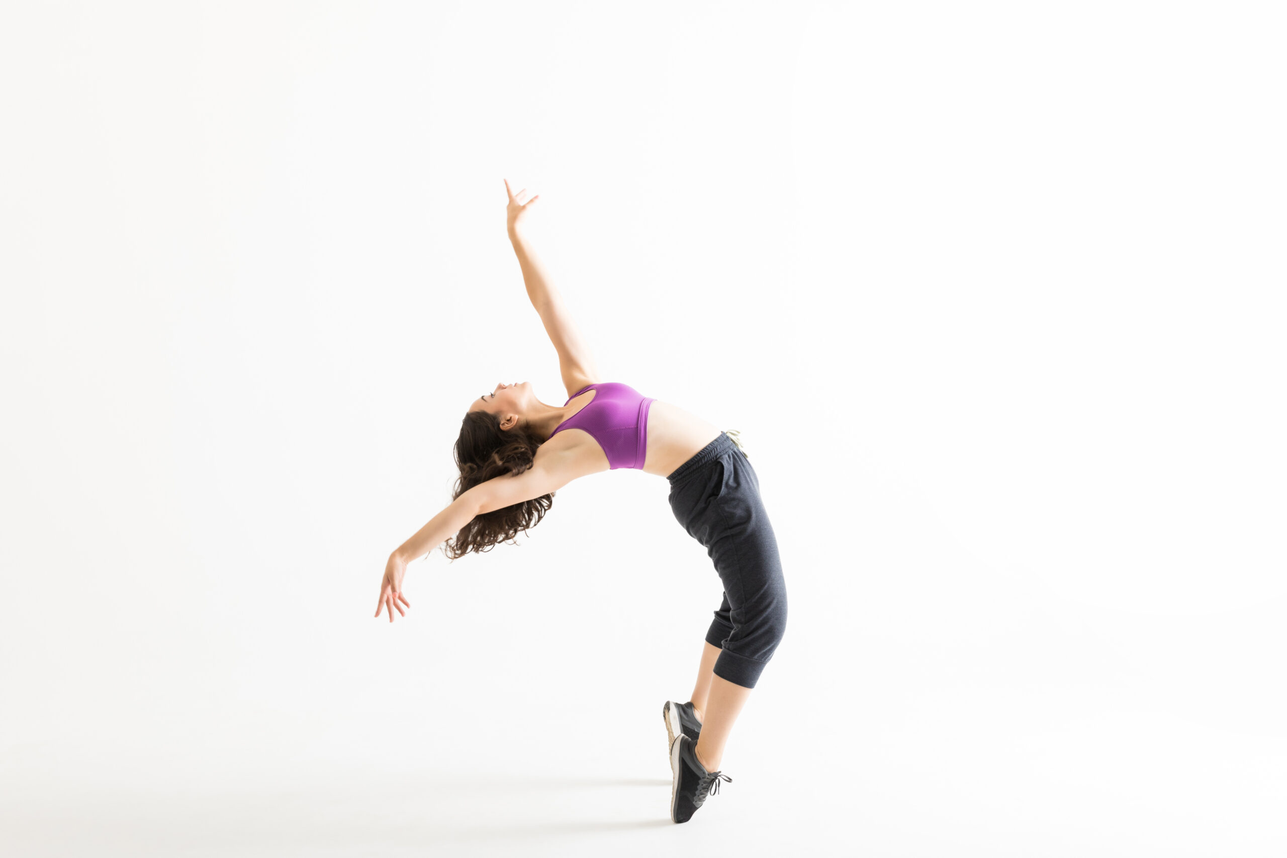 Jazz Dancer On Tiptoes Bending Backward On White Background