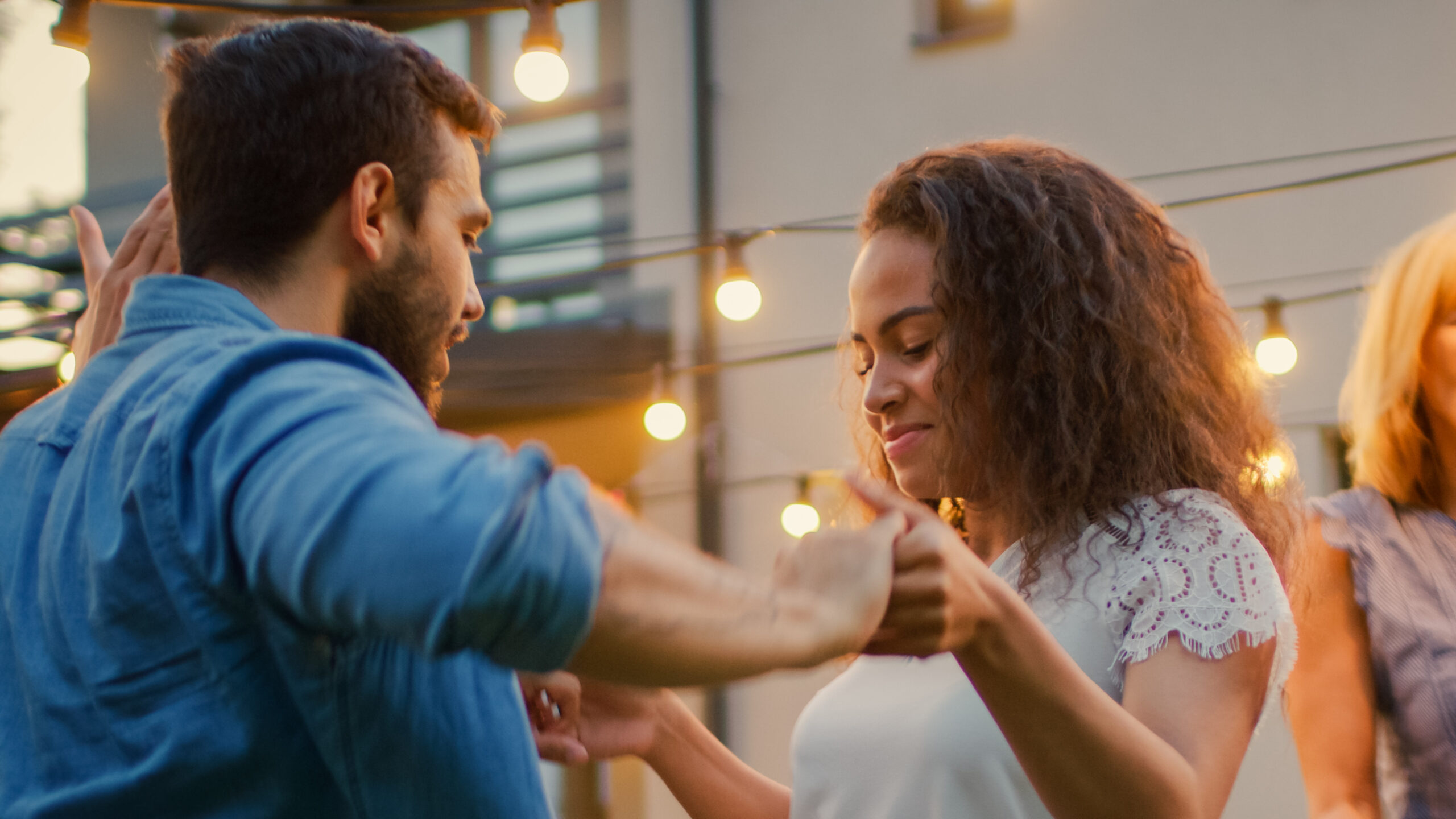 Romantic Couple Dances Together with Group of Friends at the Gar